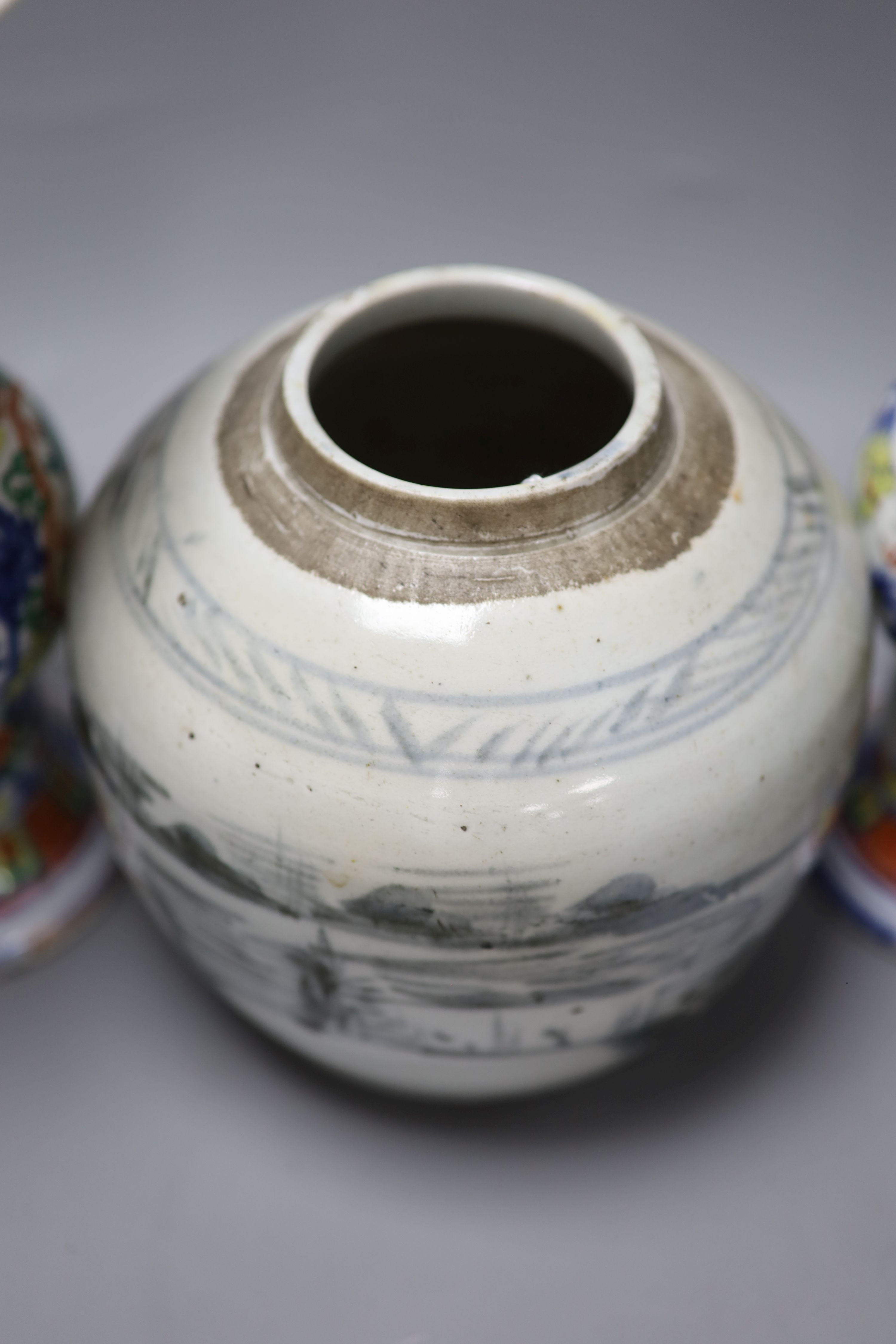 A pair of Chinese famille verte vases, height 24cm, and a jar